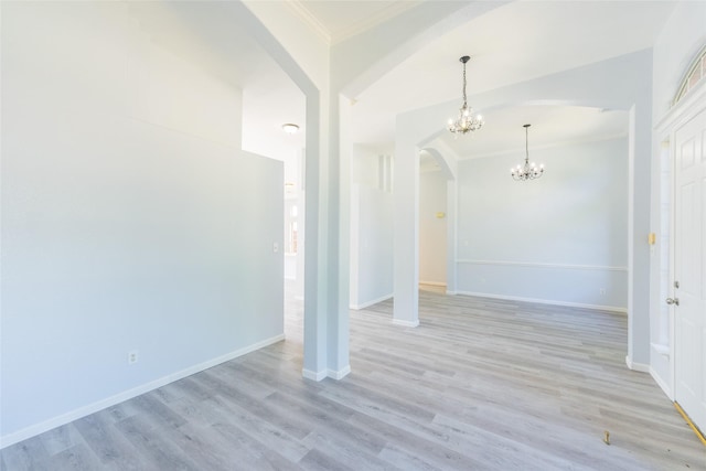 7404 Maybrook Ct, Plano, TX 75024 - unfurnished living room featuring arched walkways, ornamental molding, a chandelier, light wood finished floors, and baseboards