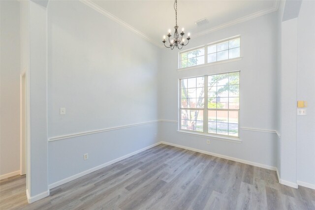 7404 Maybrook Ct, Plano, TX 75024 - empty room with a chandelier, crown molding, wood finished floors, and baseboards