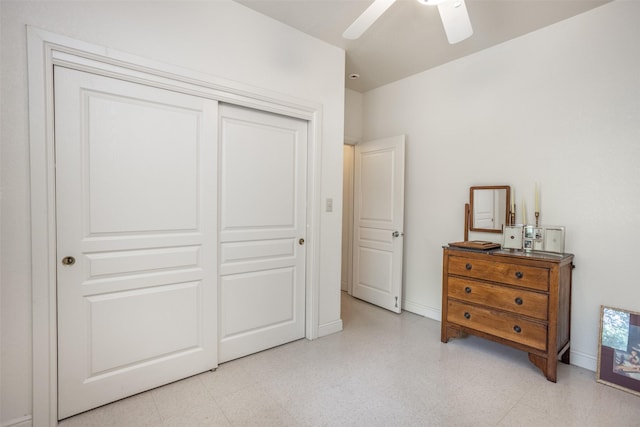 bedroom with light floors, baseboards, a ceiling fan, and a closet