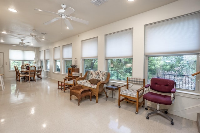 sunroom featuring baseboards, visible vents, and plenty of natural light