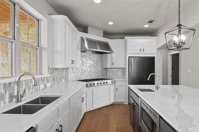 727 S Sugartree Dr, Lipan, TX 76462 - kitchen with white cabinetry, stainless steel appliances, wall chimney range hood, and a sink