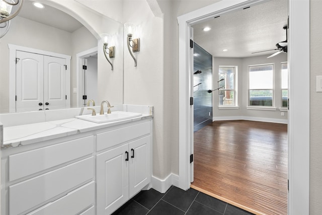 727 S Sugartree Dr, Lipan, TX 76462 - bathroom featuring vanity, a ceiling fan, tile patterned flooring, and baseboards