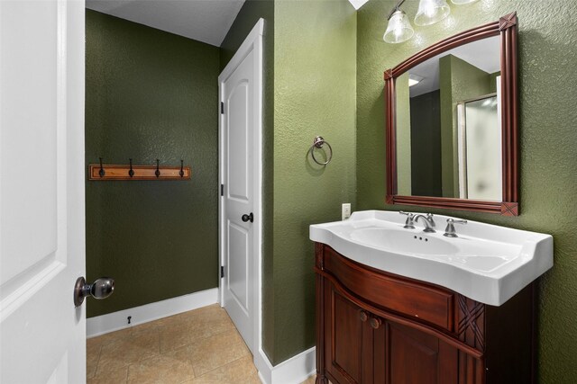 727 S Sugartree Dr, Lipan, TX 76462 - bathroom with tile patterned floors, a textured wall, vanity, and baseboards