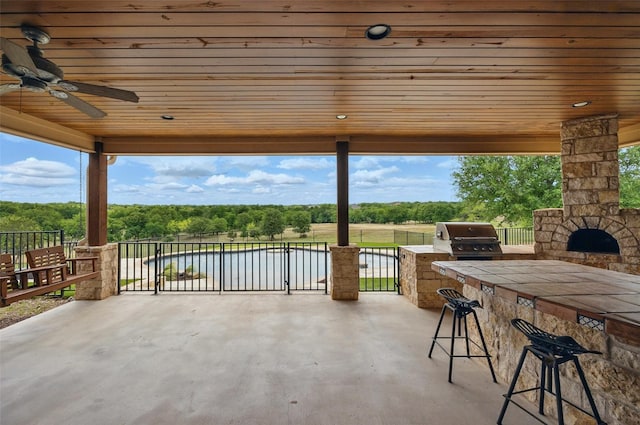 727 S Sugartree Dr, Lipan, TX 76462 - view of patio with area for grilling, grilling area, a water view, and outdoor wet bar