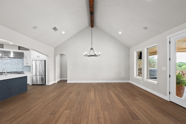 727 S Sugartree Dr, Lipan, TX 76462 - unfurnished living room with beamed ceiling, dark wood-style floors, a notable chandelier, visible vents, and arched walkways