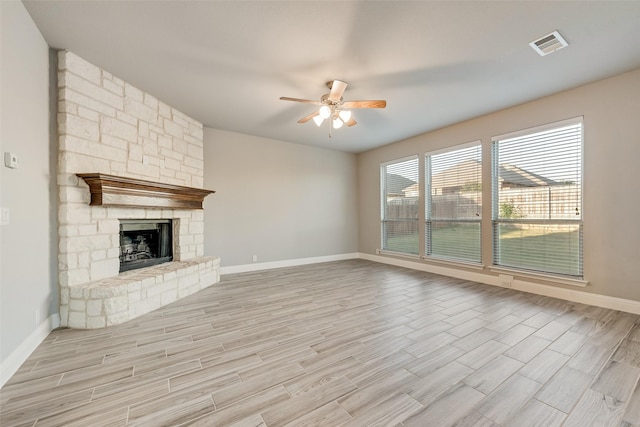 unfurnished living room with visible vents, ceiling fan, baseboards, and light wood-style floors
