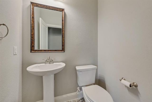 bathroom with toilet and a sink