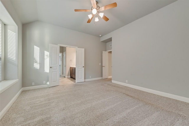 unfurnished bedroom featuring baseboards, light carpet, and multiple windows