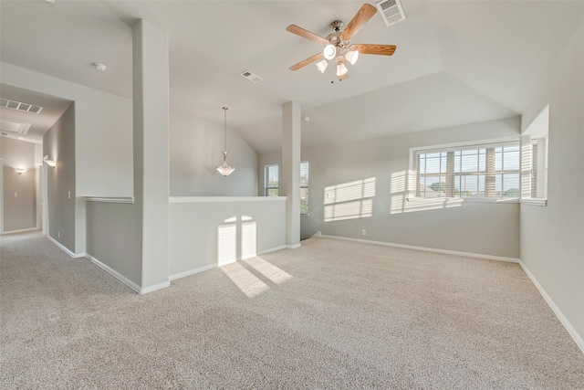 carpeted empty room with lofted ceiling, visible vents, and ceiling fan