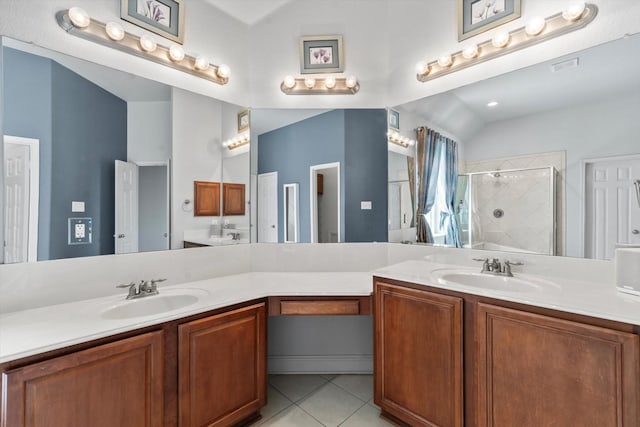 bathroom with a stall shower, tile patterned flooring, a sink, and double vanity