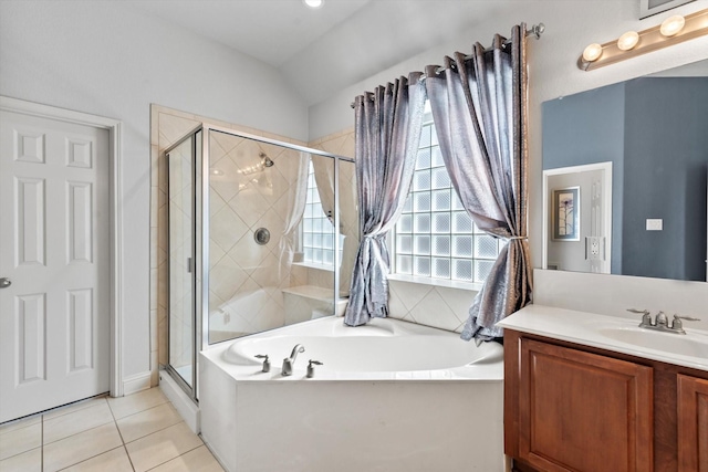 full bath featuring vanity, tile patterned floors, a stall shower, a garden tub, and lofted ceiling