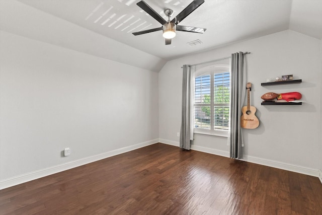 empty room with baseboards, wood finished floors, ceiling fan, and lofted ceiling