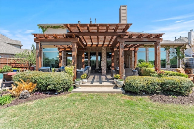 rear view of house featuring a lawn, a chimney, a pergola, and fence