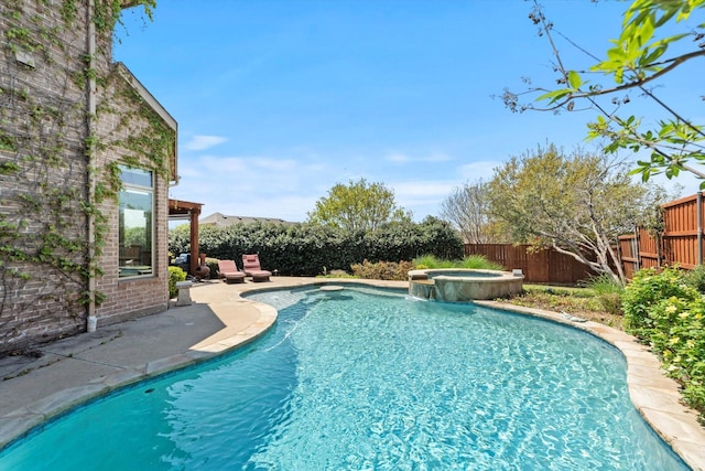 view of swimming pool featuring a pool with connected hot tub, a fenced backyard, and a patio area