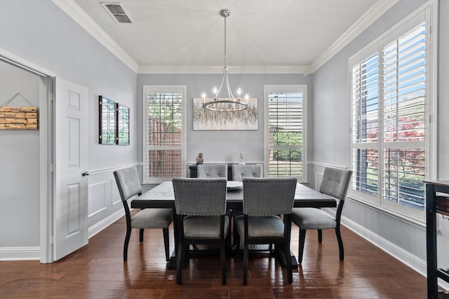 dining area with baseboards, visible vents, ornamental molding, and a notable chandelier