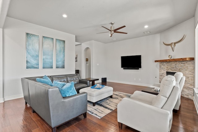 living room featuring dark wood-style floors, recessed lighting, arched walkways, and ceiling fan