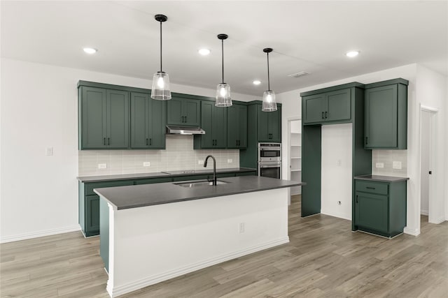 802 Roanoke, Princeton, TX 75407 - kitchen with green cabinets, dark countertops, under cabinet range hood, a sink, and double oven