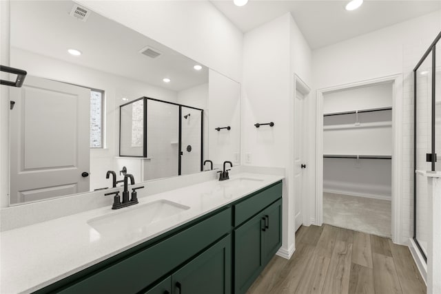 802 Roanoke, Princeton, TX 75407 - full bath featuring a stall shower, wood finished floors, a walk in closet, double vanity, and recessed lighting