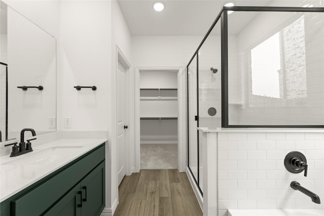 802 Roanoke, Princeton, TX 75407 - full bathroom with a shower stall, wood finished floors, vanity, a spacious closet, and recessed lighting