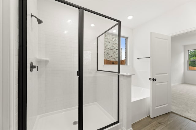 802 Roanoke, Princeton, TX 75407 - bathroom featuring wood finished floors, a stall shower, a bath, and recessed lighting
