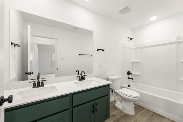 802 Roanoke, Princeton, TX 75407 - bathroom featuring toilet, wood finished floors, double vanity, and washtub / shower combination
