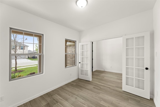 802 Roanoke, Princeton, TX 75407 - unfurnished bedroom featuring french doors, light wood finished floors, and baseboards