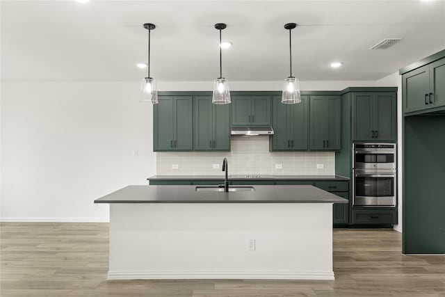802 Roanoke, Princeton, TX 75407 - kitchen with a sink, green cabinetry, under cabinet range hood, dark countertops, and recessed lighting