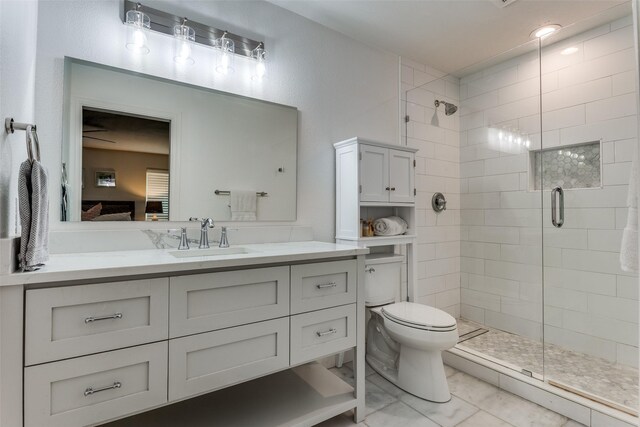 bathroom with toilet, a stall shower, and vanity