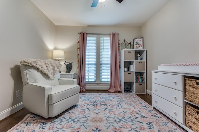 living area featuring baseboards, wood finished floors, a wealth of natural light, and ceiling fan