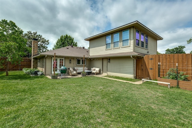 back of house featuring a chimney, an outdoor living space, a fenced backyard, a yard, and a garden