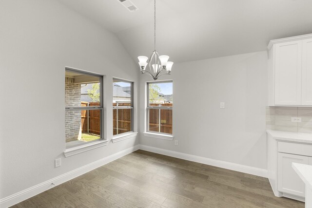 2612 Chester Dr, Celina, TX 75009 - unfurnished dining area featuring light wood-style flooring, a chandelier, baseboards, and vaulted ceiling