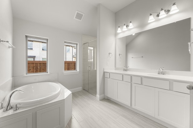 2612 Chester Dr, Celina, TX 75009 - full bathroom featuring a stall shower, a bath, baseboards, and double vanity