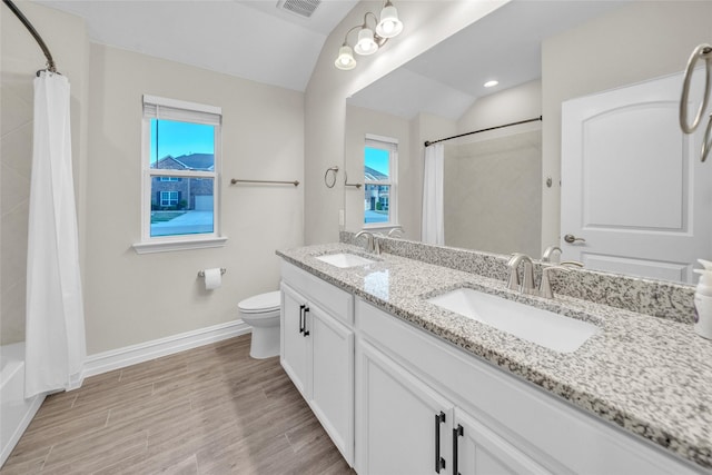 full bath featuring plenty of natural light, toilet, baseboards, and a sink
