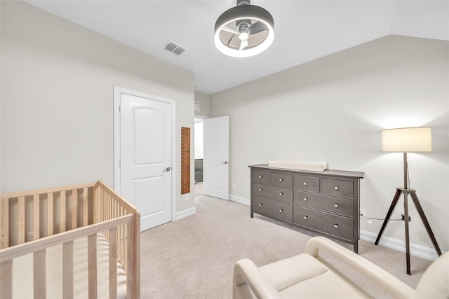 bedroom with carpet flooring, a crib, visible vents, and baseboards