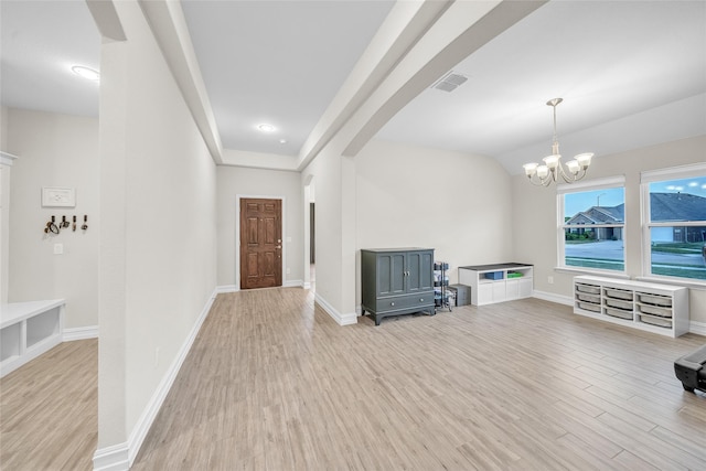 interior space featuring visible vents, arched walkways, an inviting chandelier, baseboards, and light wood finished floors