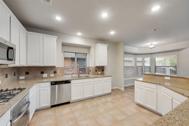 kitchen with recessed lighting, decorative backsplash, stainless steel appliances, a sink, and visible vents