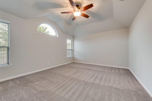 spare room with lofted ceiling, ceiling fan, carpet floors, and baseboards