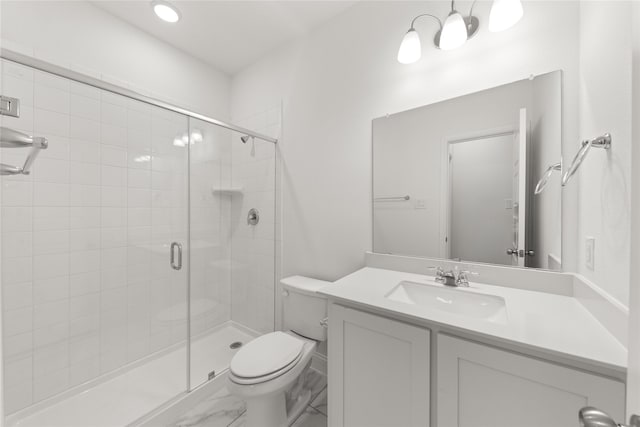 bathroom featuring toilet, a stall shower, marble finish floor, and vanity