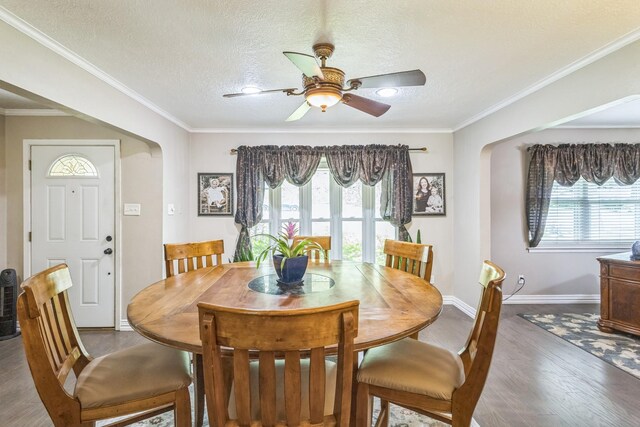 dining space featuring baseboards, a ceiling fan, and a healthy amount of sunlight