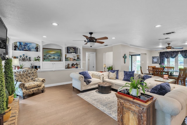 bedroom featuring ornamental molding, a ceiling fan, dark wood-style floors, and multiple windows