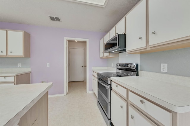 637 Gibson St, Cedar Hill, TX 75104 - kitchen featuring appliances with stainless steel finishes, light countertops, light floors, baseboards, and white cabinetry