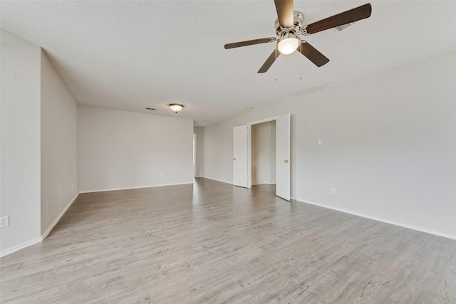 unfurnished room with baseboards, a ceiling fan, and wood finished floors