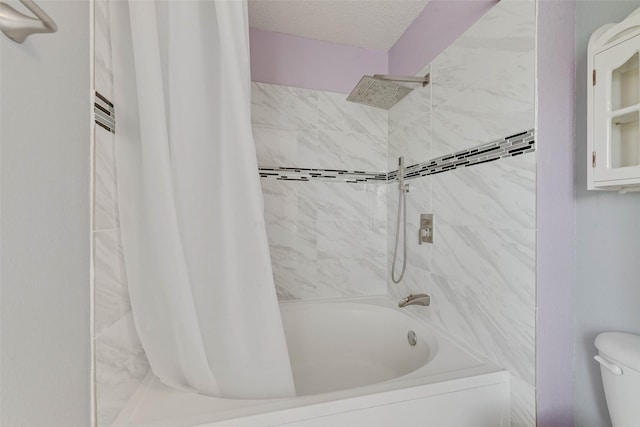 bathroom featuring a textured ceiling, shower / bath combination with curtain, and toilet