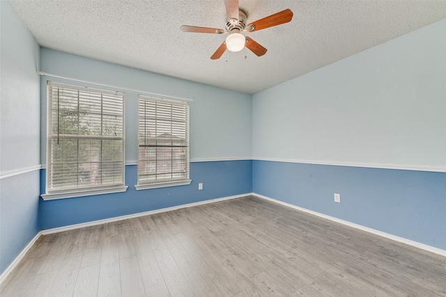 unfurnished room featuring a textured ceiling, ceiling fan, a healthy amount of sunlight, and wood finished floors