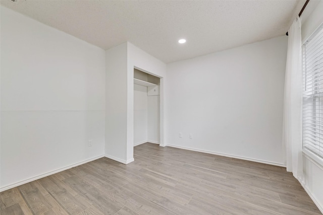 unfurnished bedroom featuring recessed lighting, baseboards, and wood finished floors