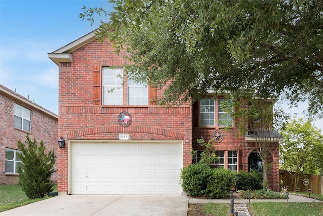 traditional-style home featuring an attached garage, concrete driveway, and brick siding