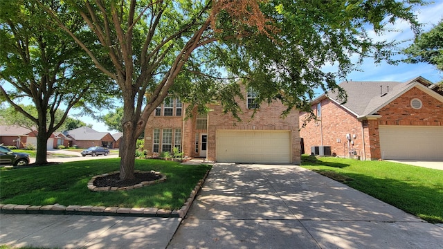 12165 Shoal Creek Dr, Frisco, TX 75035 - traditional home with concrete driveway, brick siding, a front lawn, and central AC