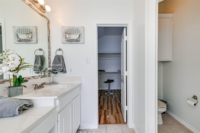 12165 Shoal Creek Dr, Frisco, TX 75035 - full bathroom with toilet, vanity, tile patterned floors, and baseboards