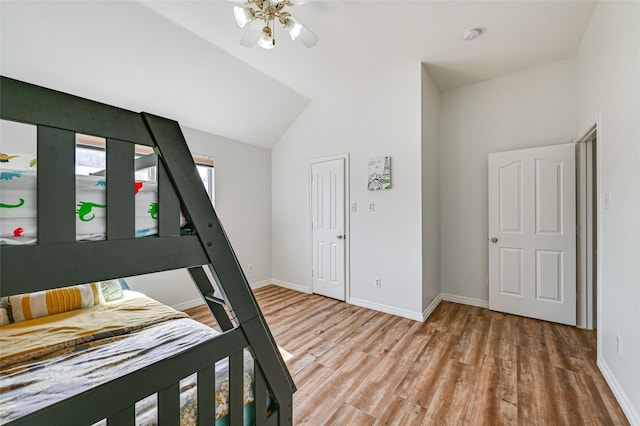 12165 Shoal Creek Dr, Frisco, TX 75035 - bedroom with wood finished floors, baseboards, and lofted ceiling