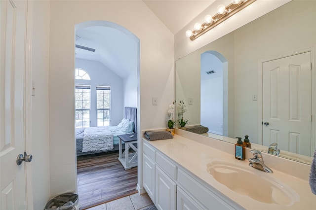 12165 Shoal Creek Dr, Frisco, TX 75035 - bathroom with lofted ceiling, vanity, ensuite bathroom, and tile patterned flooring